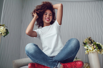 Curly haired girl with freckles in blank white t-shirt. Mock up.