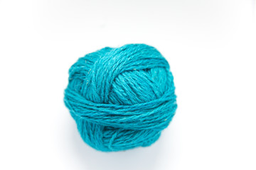 Small colorful ball of wool yarn on a white background. Hand craft supplies.
