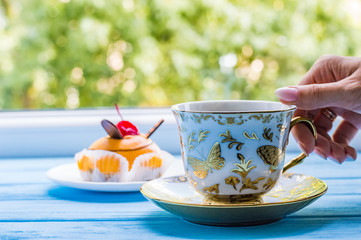 Still life with cup of tea on the wooden background