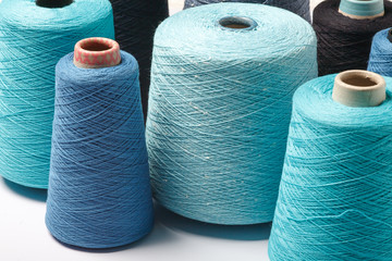 Colored cones of thread isolated on white background