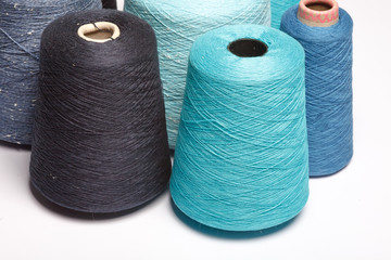 Colored cones of thread isolated on white background