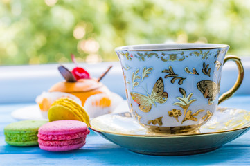 Still life with cup of tea on the wooden background