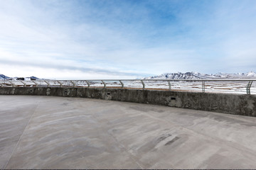 empty concrete floor with beautiful snow mountains