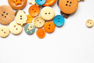 Beautiful colorful buttons on a white background. Beautiful handcraft composition. A button on a white background.