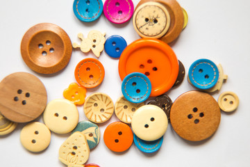 Beautiful colorful buttons on a white background. Beautiful handcraft composition. A button on a white background.