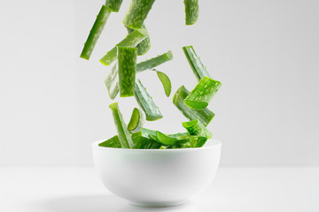 Aloe Vera sliced,High speed freeze action shot of a lime splashing into dish with a white background
