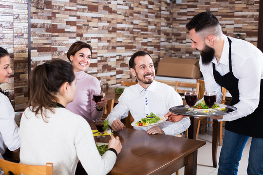 Waiter placing order in restaurant