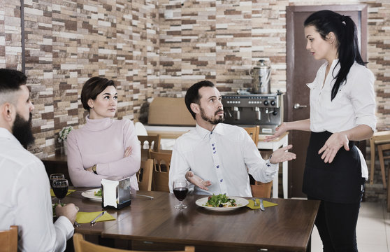 Unpleased client talking with manager in restaurant