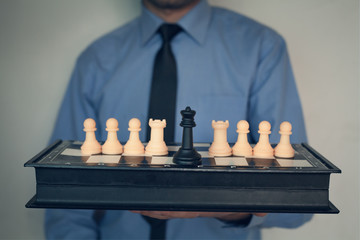 Businessman holding chess. Leader concept.
