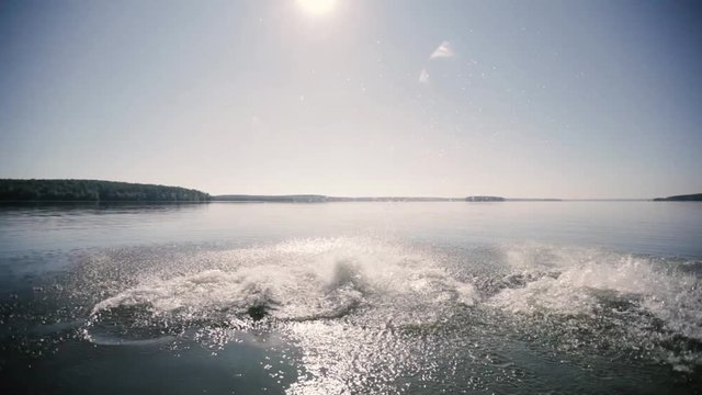 four guys run down the pier and jump into the lake
