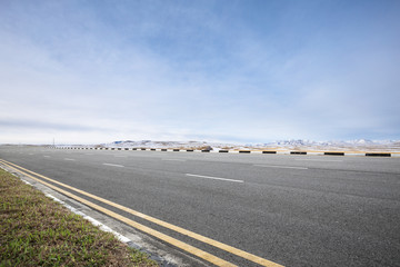 empty asphalt road with beautiful snow mountains