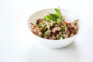 Topped with stir fried pork and basil