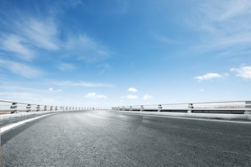 empty asphalt road with snow mountains