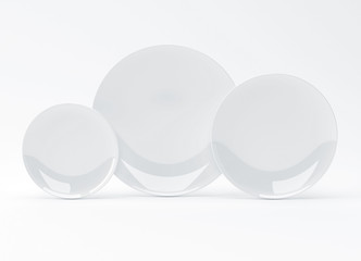 Plates of three different sizes on white background, 3D rendering