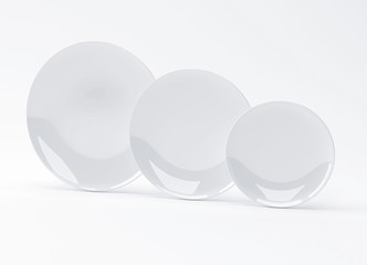 Plates of three different sizes on white background, 3D rendering