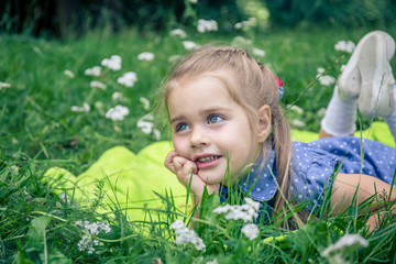 little girl smiling in a park