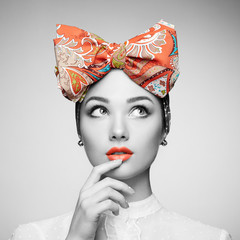 Portrait of beautiful young woman with bow. Brunette girl. Beauty fashion. Cosmetic make-up