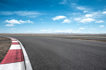 empty asphalt road with snow mountains