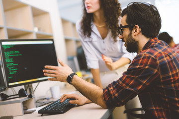 Software engineers working on project and programming in company