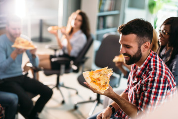 Software enginneers sharing pizza on break from work