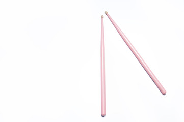 Pink drumsticks on white background