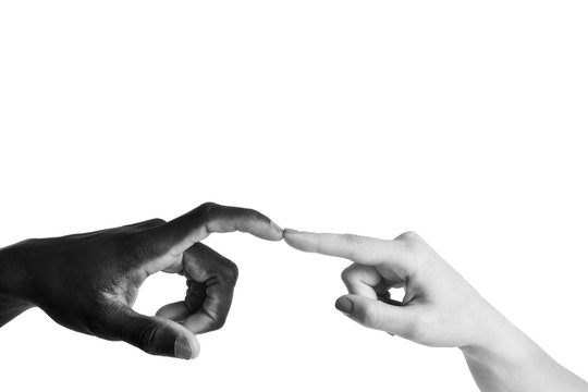 One caucasian and one african hand on white background