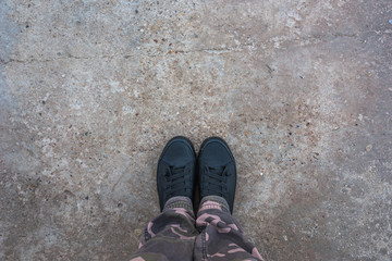 Modern new sneakers on concrete sidewalk surface