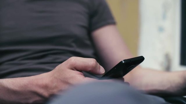 Man's hand scrolling in smartphone