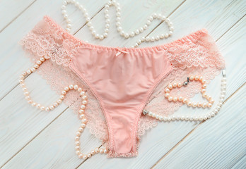 Delicate pink lace panties and pearl beads