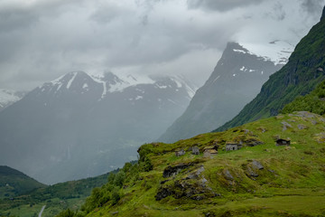 Obraz premium Norwegian traditional wooden houses in middle of mountains close to famous Geiranger fjord.