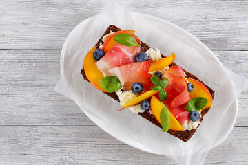 sandwich with cream cheese, prosciutto, basil