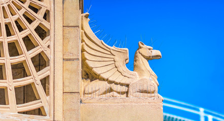 An art deco water fountain at a public park  in St Kilda, Australia, featuring a carved griffin covered in anti bird spikes