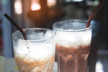 Close up of iced coffee and iced chocolate in glasses