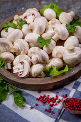 Fresh champignon mushrooms on wooden table