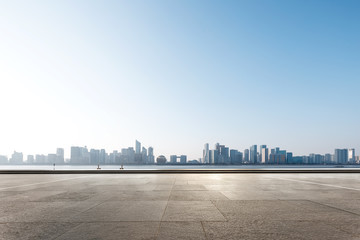 empty marble floor with cityscape of modern city © zhu difeng