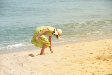 Beautiful happy multiracial Asian girl in vintage dresses walking on the beach.