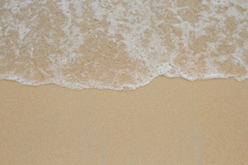 Beach wave tide on sand background