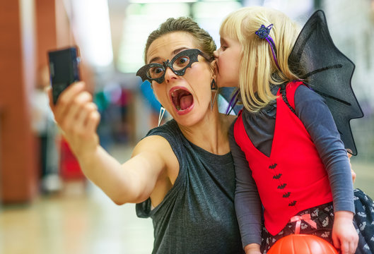 mother and daughter taking scary Halloween selfie on digital pho