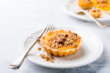 Pumpkin mini pie, tartlet made for Thanksgiving day on gray stone background. Healthy autunm food concept with copy space.