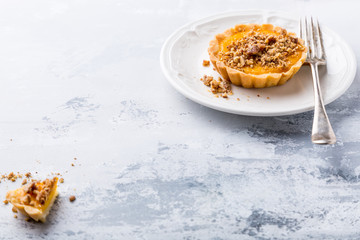 Pumpkin mini pie, tartlet made for Thanksgiving day on gray stone background. Healthy autunm food concept with copy space.