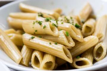 Pasta with pesto sauce and nuts on a the table