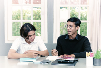 Teenage Boy Studying With Home Tutor