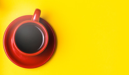 Red Cup with black coffee on a yellow background