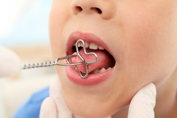 Cute boy at speech therapist's office, closeup