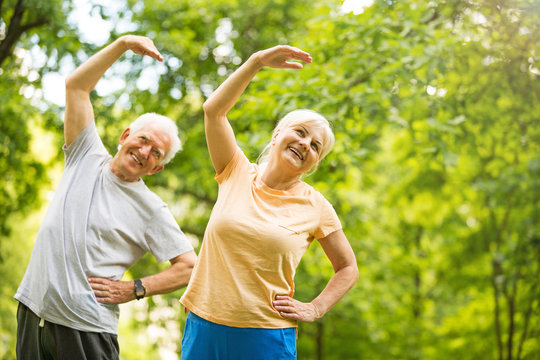 Senior Couple Exercising In Park
