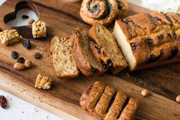 Sliced bread and buns on the wooden cutting board