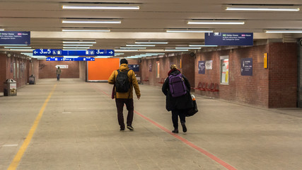 Couple at a train station on their way home from Schönefeld Airport in Berlin