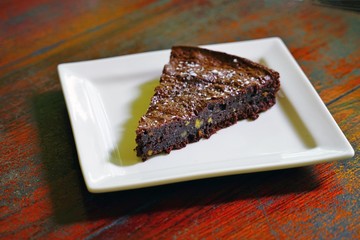 A slice of vegan chocolate and walnut cake