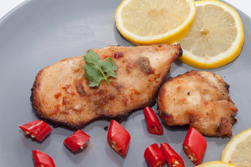 Roast chicken with chilli, lemon on plate