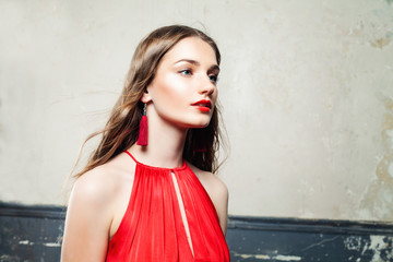 Beautiful Woman with Long Hair, Makeup and Red Earrings